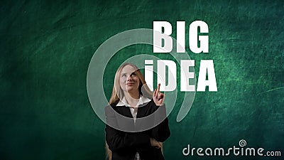 Portrait of woman isolated on green background with digital text. Girl standing thinking wondering, having idea pointing Stock Photo