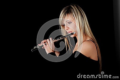 Portrait of a woman playing transverse flute Stock Photo