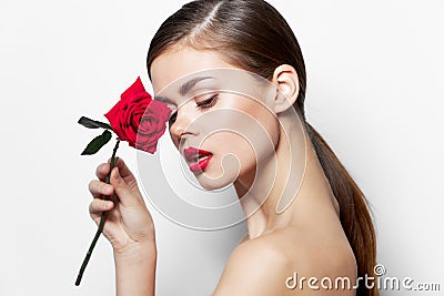 Portrait of woman Red lips nude model shoulders with rose bright makeup Stock Photo