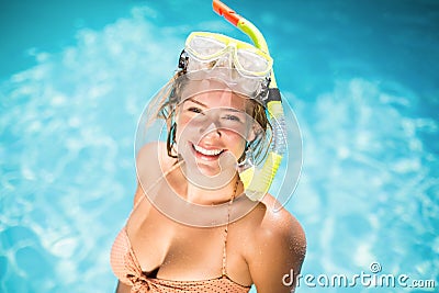 Portrait of woman sitting by swimming pool with a snorkel Stock Photo