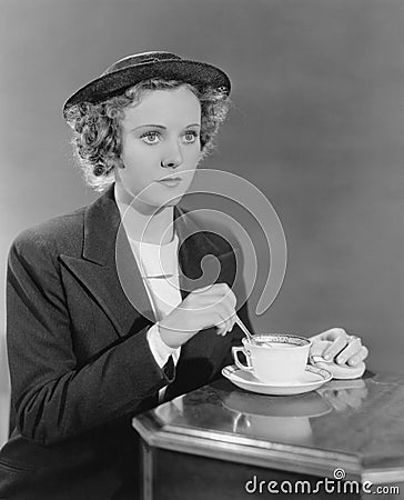 Portrait of woman stirring beverage Stock Photo