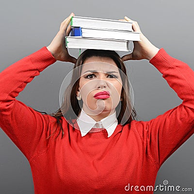 Portrait of woman student tired of learning against gray background Stock Photo