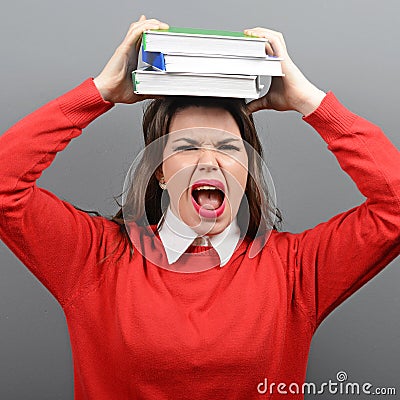 Portrait of woman student tired of learning against gray background Stock Photo