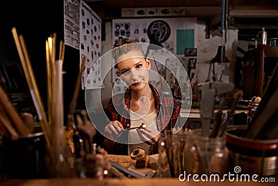 Portrait, woman and tools with wood in workshop with craftsmanship, knife or handmade design and creativity. Woodwork Stock Photo