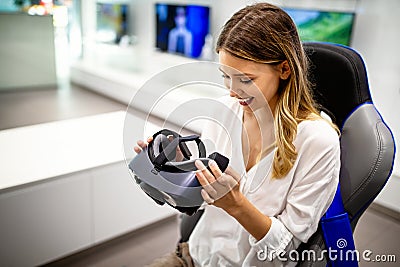 Portrait of woman using virtual reality headset at exhibition show. VR technology simulation concept Stock Photo