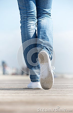 Portrait of a woman walking outdoors in comfortable white shoes Stock Photo