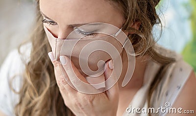 Portrait of woman wearing handmade cotton fabric face mask. Protection against saliva, cough, dust, pollution, virus, bacteria, Stock Photo
