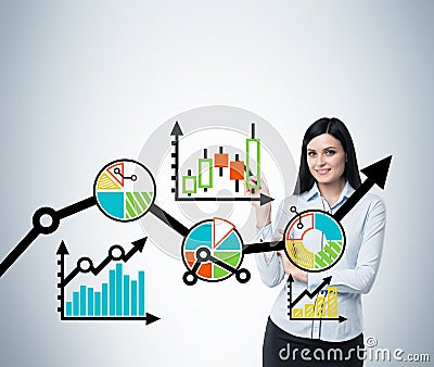 Portrait of woman who points out the business optimisation scheme. Colourful scheme of the business process on the glass s Stock Photo