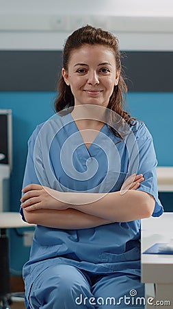 Portrait of woman working as medical assistant at desk Stock Photo