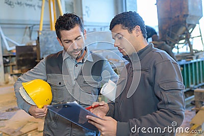 Portrait workers during conversation in factory Stock Photo