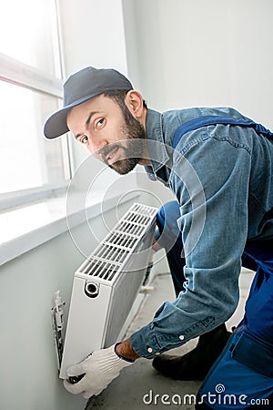 Workman mounting radiator Stock Photo