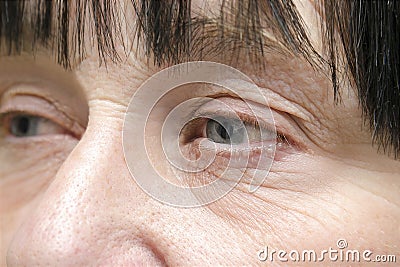 wrinkled face of elderly mature middle aged woman,female eyes with dry skin.cosmetology,skin care Stock Photo