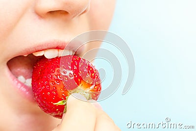 Portrait of yaung woman eating strawberries. Healthy happy smiling woman eating strawberry. Stock Photo