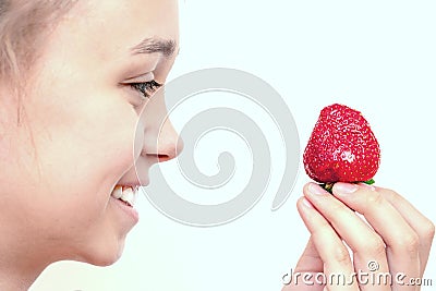 Portrait of yaung woman eating strawberries. Stock Photo