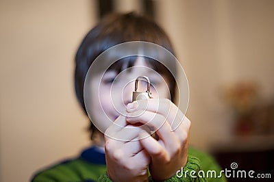 10 year old child portrait showing a small padlock in hands Stock Photo