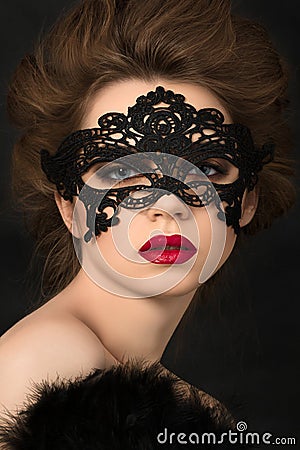 Portrait of young adorable woman in black party mask Stock Photo