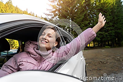 Portrait of young adult beautiful caucasian woman driver enjoy roadtrip adventure traveling by car on mountain nature Stock Photo