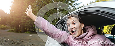 Portrait of young adult beautiful caucasian woman driver enjoy roadtrip adventure traveling by car on mountain nature Stock Photo