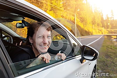 Portrait of young adult beautiful caucasian woman driver enjoy roadtrip adventure traveling by car on mountain nature Stock Photo