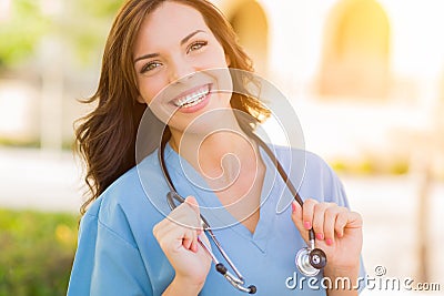 Portrait of Young Adult Female Doctor or Nurse Wearing Scrubs an Stock Photo