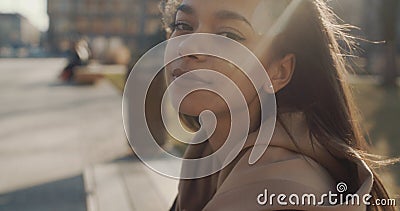 Portrait of young African American woman looking to a camera, outdoors. Slow motion. Stock Photo