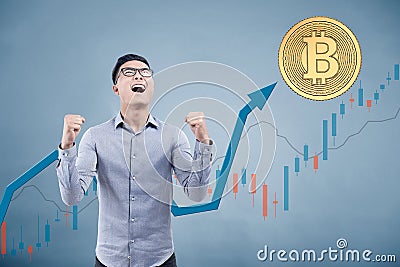 Happy Asian businessman, bitcoin, graphs Stock Photo