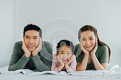 Portrait of young Asian family facing camera Stock Photo