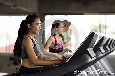 woman run on treadmills, control machine Stock Photo