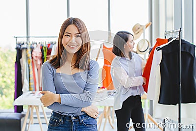 Portrait Young Asian SME Business owner happy smile with her new clothing shop grand opening day promotion and customer care Stock Photo