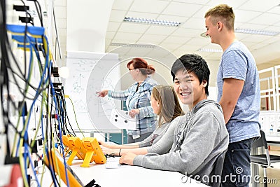 Portrait of young Asians in vocational training, in the background group of apprentices and teacher in class Stock Photo