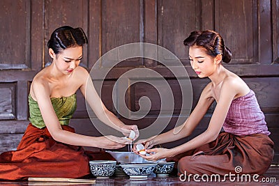 Portrait young asians women dressed in ancient Thailand are helping to make the dessert thai of Thai culture Stock Photo