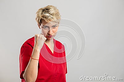 Portrait of young attractive female nurse showing fist like fighting Stock Photo