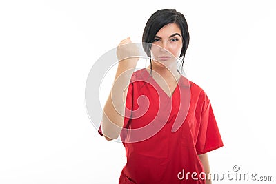 Portrait of young attractive female nurse showing fist like fighting Stock Photo