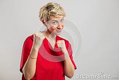 Portrait of young attractive female nurse showing fists like fighting Stock Photo