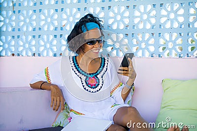 Portrait of young attractive and happy hipster Asian woman having fun relaxed using internet mobile phone at relaxing outdoors bed Stock Photo