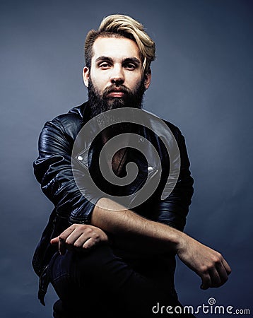 Portrait of young bearded hipster guy smiling on gray dark background close up, brutal modern man, lifestyle people Stock Photo