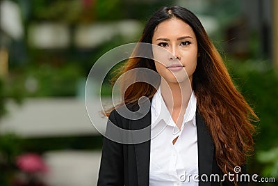 Young beautiful Asian businesswoman in the park Stock Photo