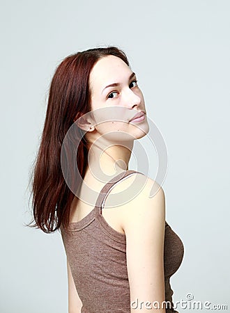 Portrait of a young beautiful brunette in a shirt, light background Stock Photo
