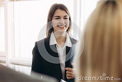 Portrait of young beautiful business woman in the office meeting new workers Stock Photo