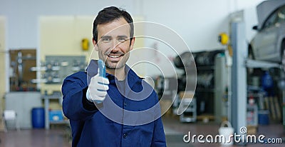 Portrait of a young beautiful car mechanic in a car workshop, in the background of service. Concept: repair of machines, fault dia Stock Photo