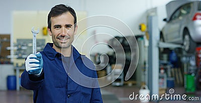 Portrait of a young beautiful car mechanic in a car workshop, in the background of service. Concept: repair of machines, fault dia Stock Photo
