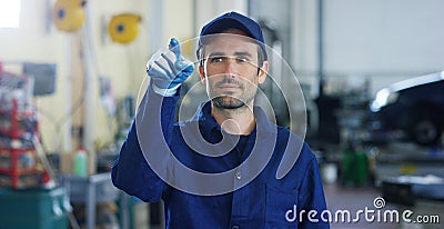 Portrait of a young beautiful car mechanic in a car workshop, in the background of service. Concept: repair of machines, fault dia Stock Photo