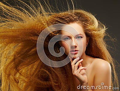 Long-haired curly redhead woman Stock Photo