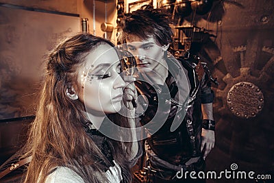 Portrait of a young beautiful loving couple in steampunk style. Stock Photo