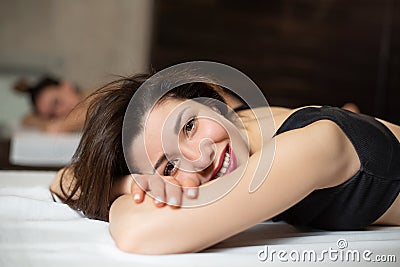 Portrait of young beautiful model girl on wooden loungers relaxing in a sauna. Beauty and wellness lifestyle Stock Photo