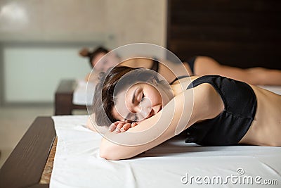 Portrait of young beautiful model girl on wooden loungers relaxing in a sauna. Beauty and wellness lifestyle Stock Photo