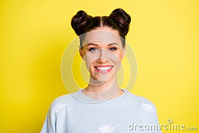 Portrait of young beautiful pretty charming smiling girl with top-knots wear light blue jumper isolated on yellow color Stock Photo