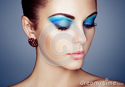 Portrait of young beautiful woman with blue makeup Stock Photo