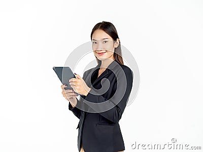 Portrait of young beauty Asian Businesswoman in black suit holding and using tablet Stock Photo