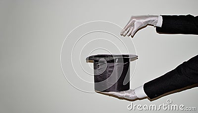 Portrait of young black Illusionist magician doing magic with a top hat Stock Photo